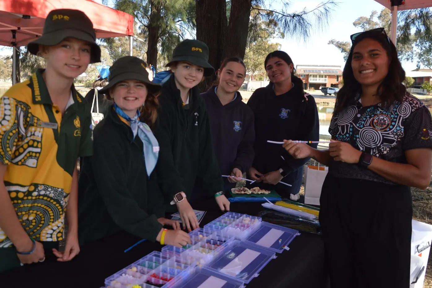 Georgia Pengilly, Hariett Herbert, Heidi Symonds, Hayley Hall and Kailei Coe with Norma Stevenson from Yoorana Gunya made braclets at the Forbes NAIDOC celebration.