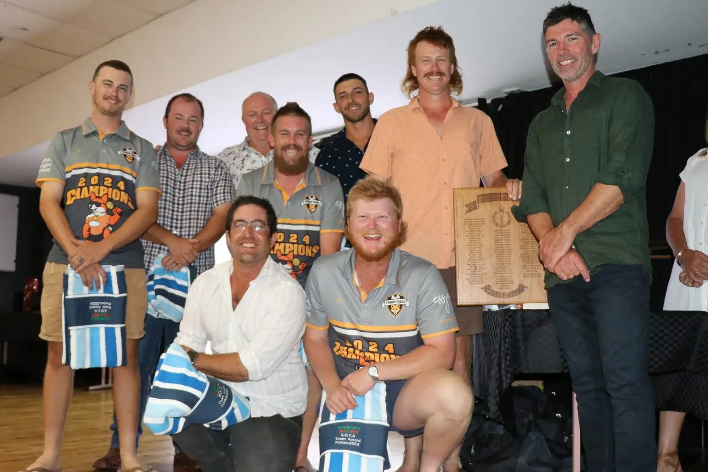 Nick Field congratulates members of Team of the Year Forbes Foxes at the SOYA awards.