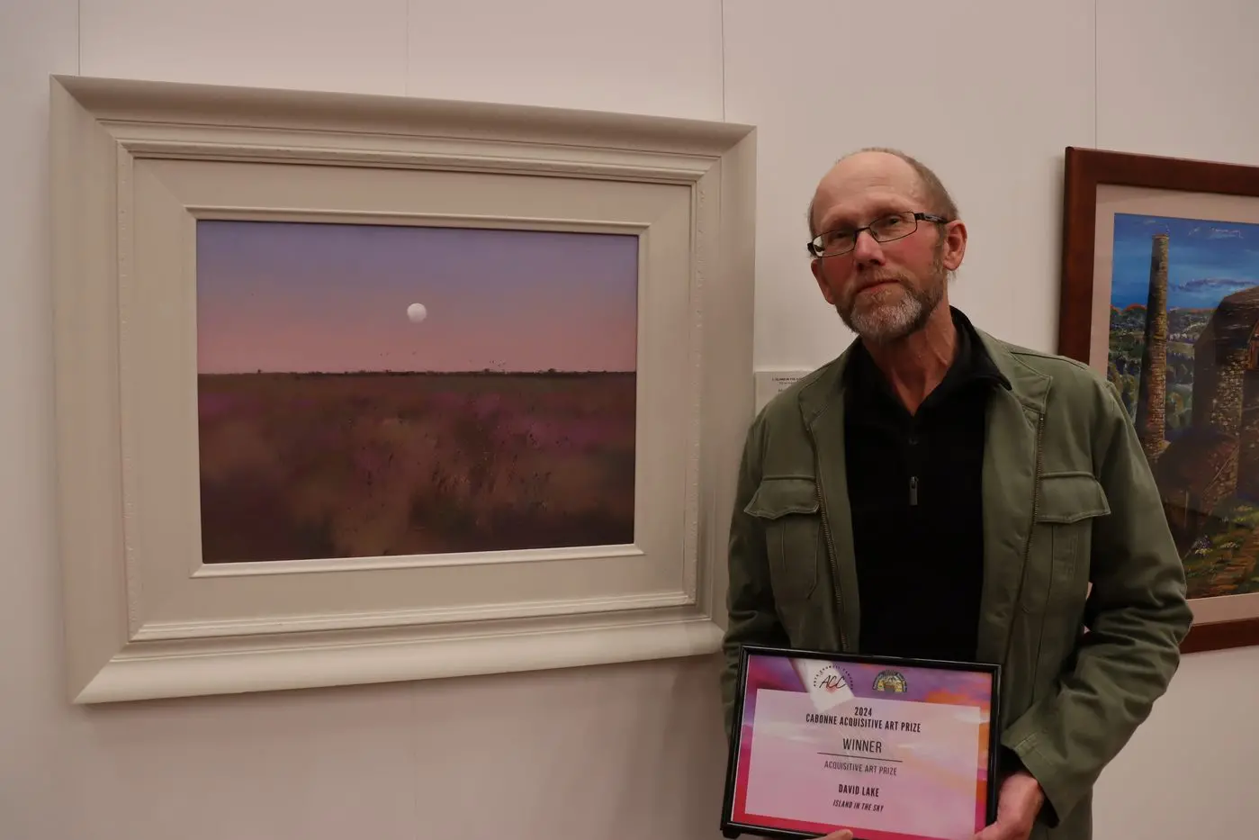 Winner of the 2024 Acquisitive Art Prize David Lake with his artwork, Island In The Sky. PHOTO: Cabonne Council