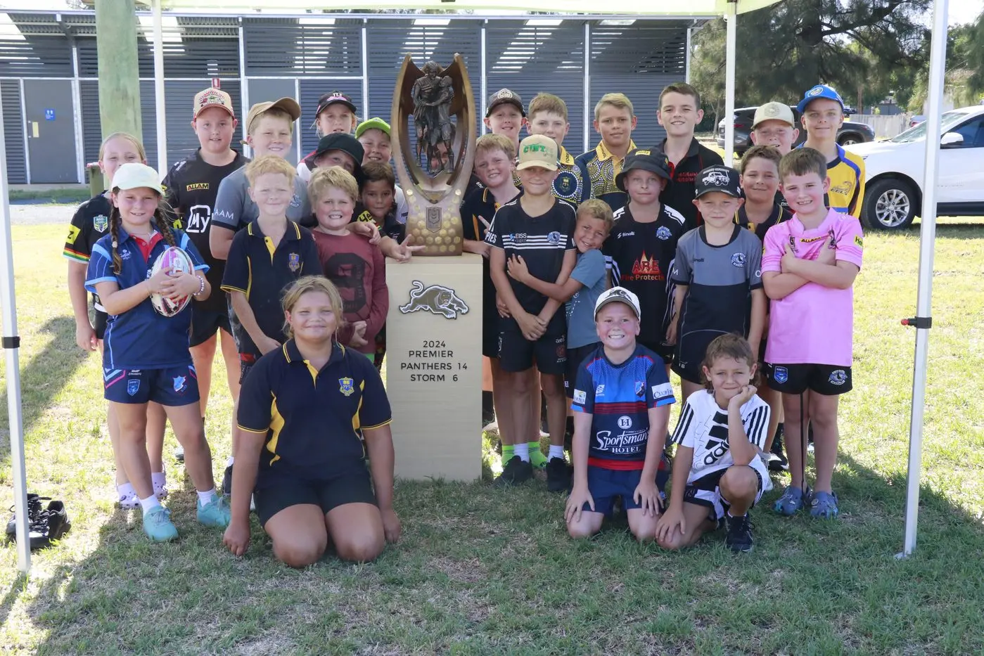 These kids were thrilled to kick a footy around with NRL development officers and pose for a photo with the Penrith Panthers premiership trophy.