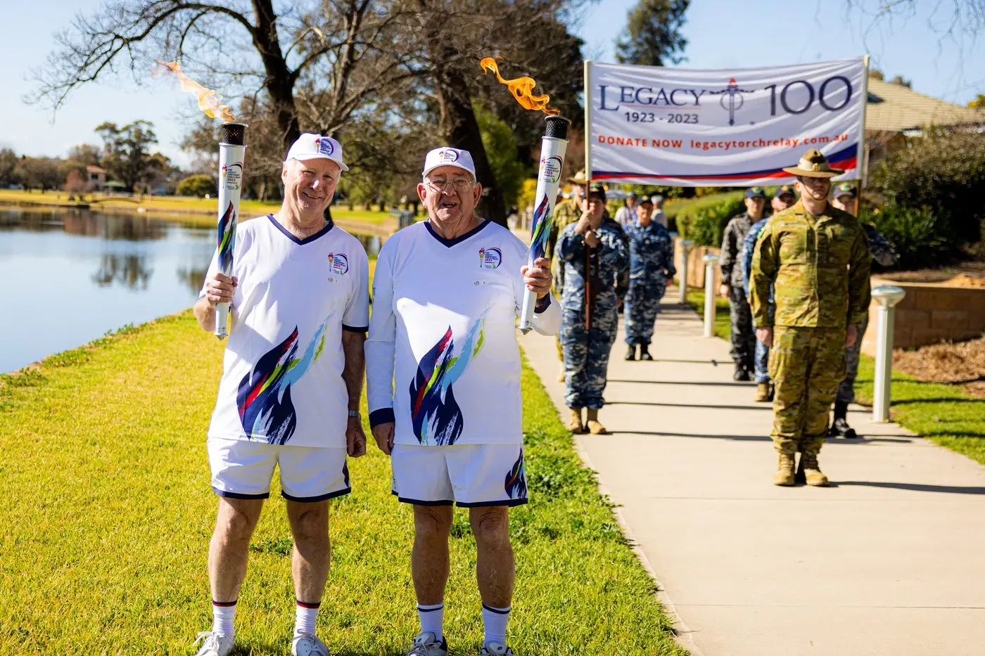 Forbes\\' Martin Cunningham and Frank Hanns bearing the torch for Legacy in the centenary relay. PHOTO: CSmith Photography