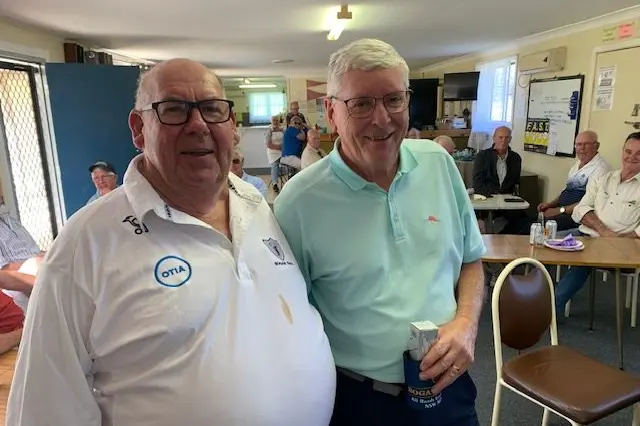 Bogan Gate golf club representative Steve Edwards congratulates Parkes\\' Gordon Pritchard on his win.