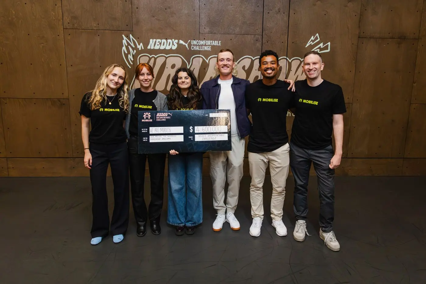 Nedd Brockmann presents a checque for $4.6million to Noah Yang and the Mobilise team. PHOTO: Marty Rowney/Bursty