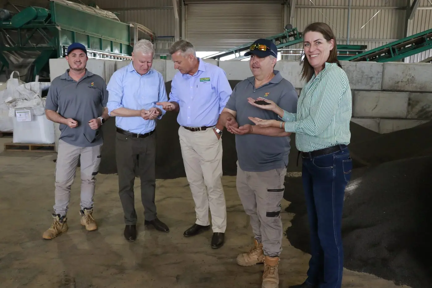 Mark Pobje at Southern Cross Nutrients showing the granules to MP Michael McCormack, candidate for Parkes Jamie Chaffey and Senator Perrin Davey on their visit to Forbes. 