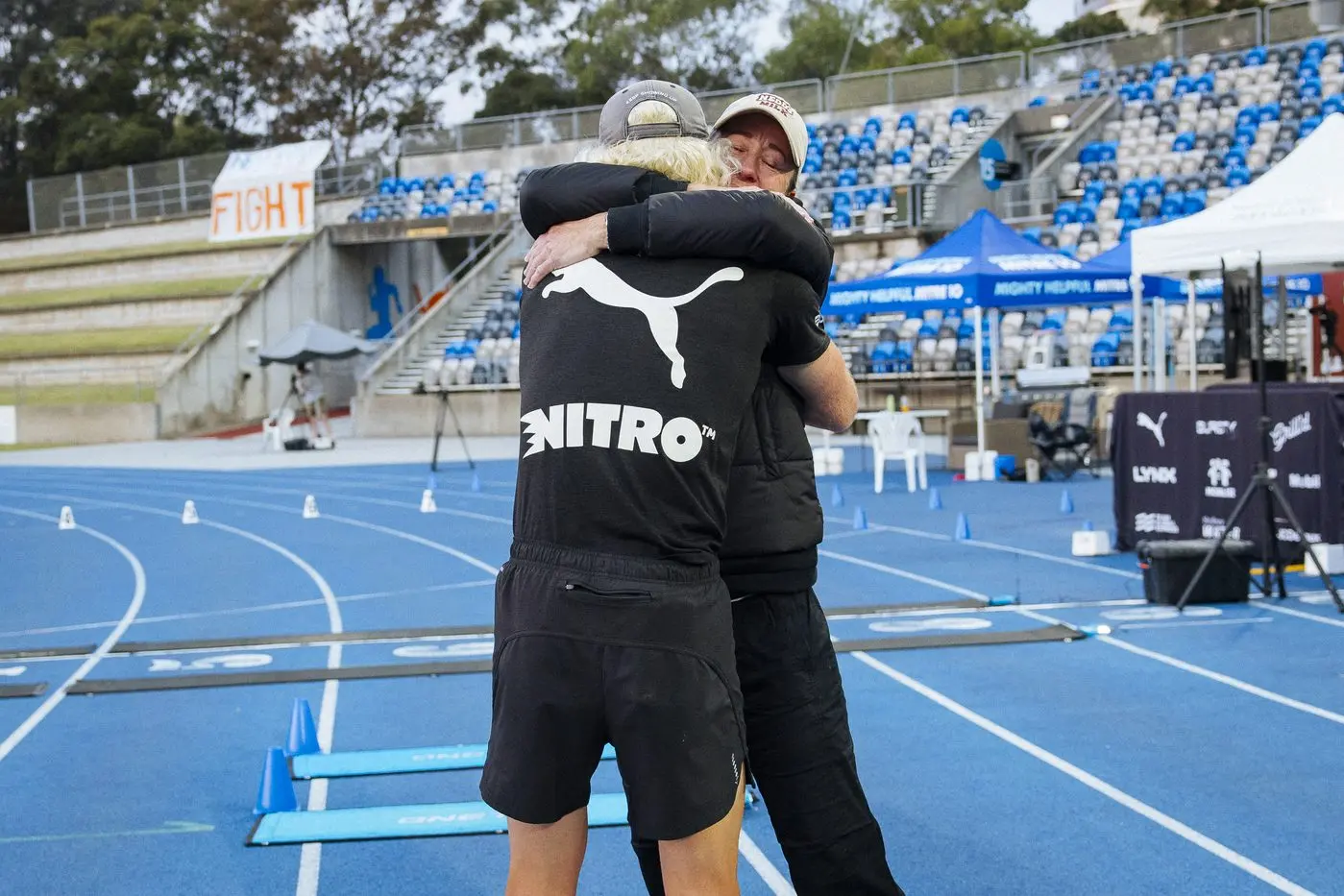 A hug for mum Kylie Brockmann at the finish line. PHOTO: Marty Rowney/Bursty