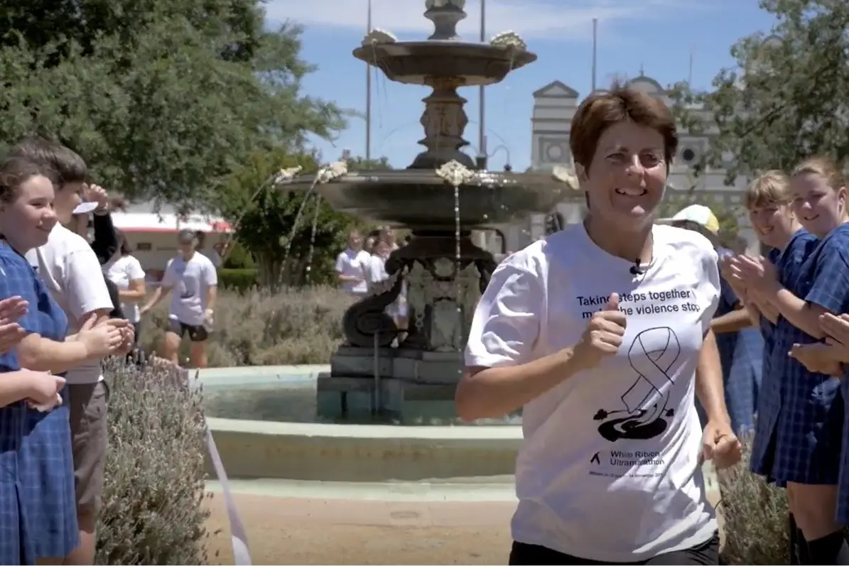 Kirrily Dear is welcomed into Forbes at the end of her 860km White Ribbon run in 2014. PHOTO: Run Against Violence