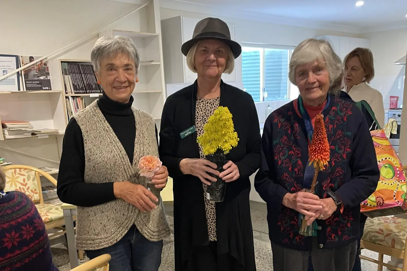 Denise Thurston, Irene Ford and Marie Langfield showing their prize winning entries in Flower of the month.