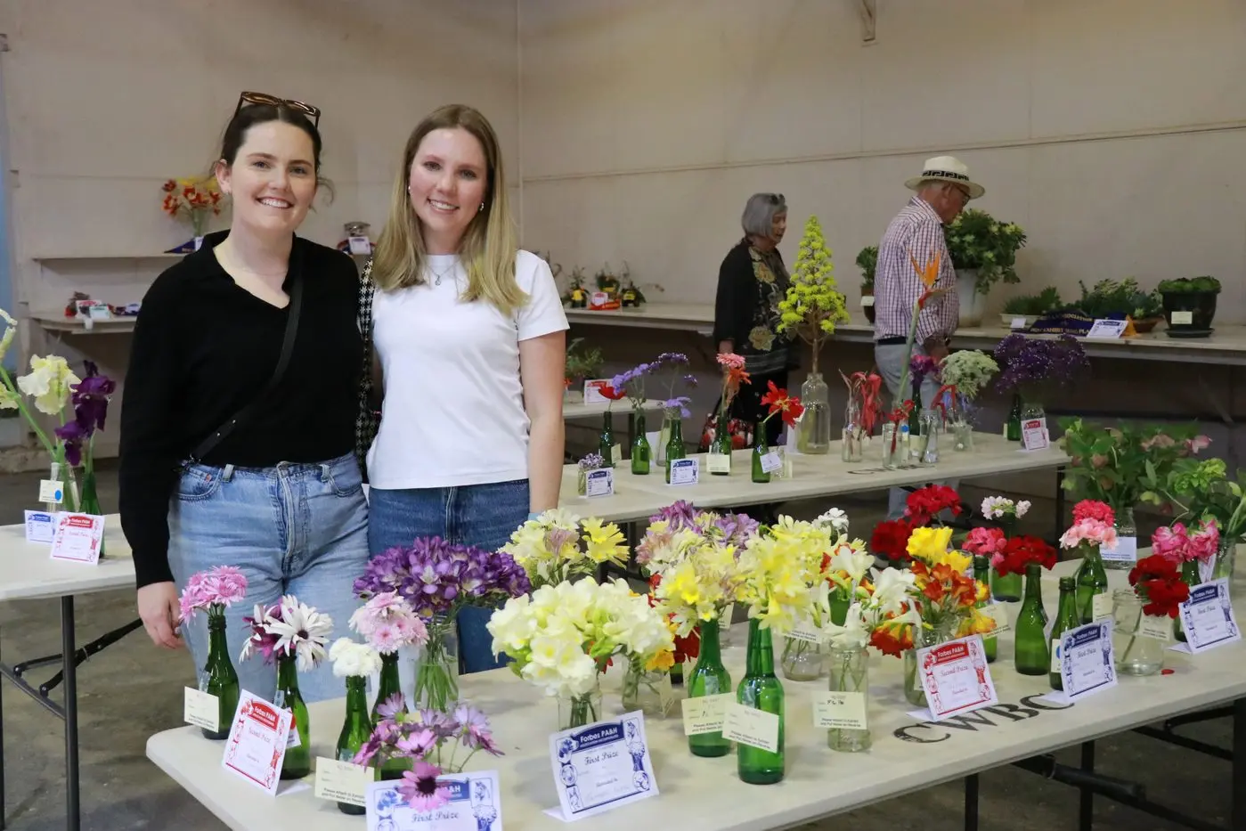 Georgia Woods and Alice Morrison admiring the floral entries in the pavilion. 