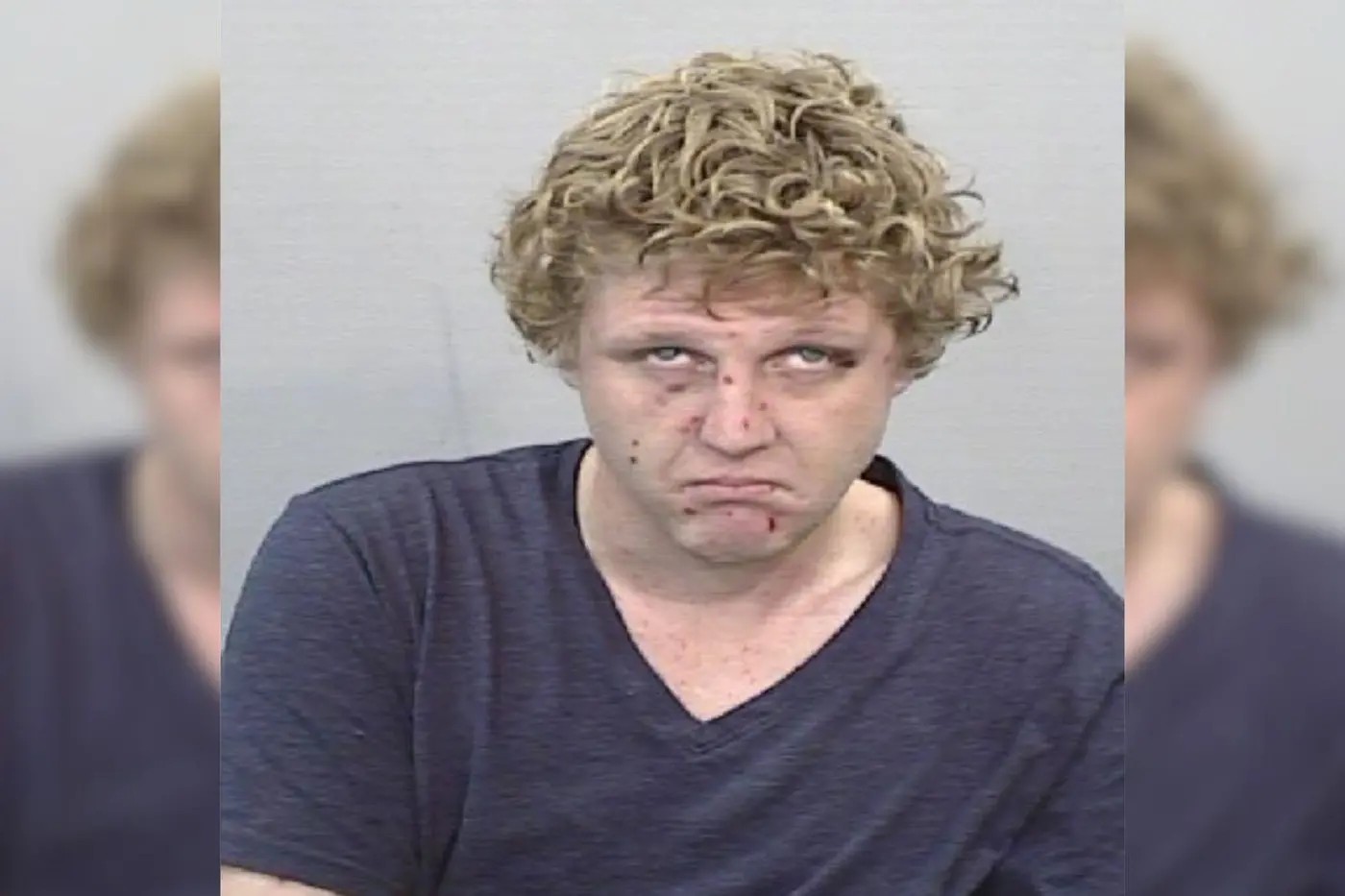 Kane Mines, 28, is wanted on an outstanding warrant for an alleged domestic violence-related offence.