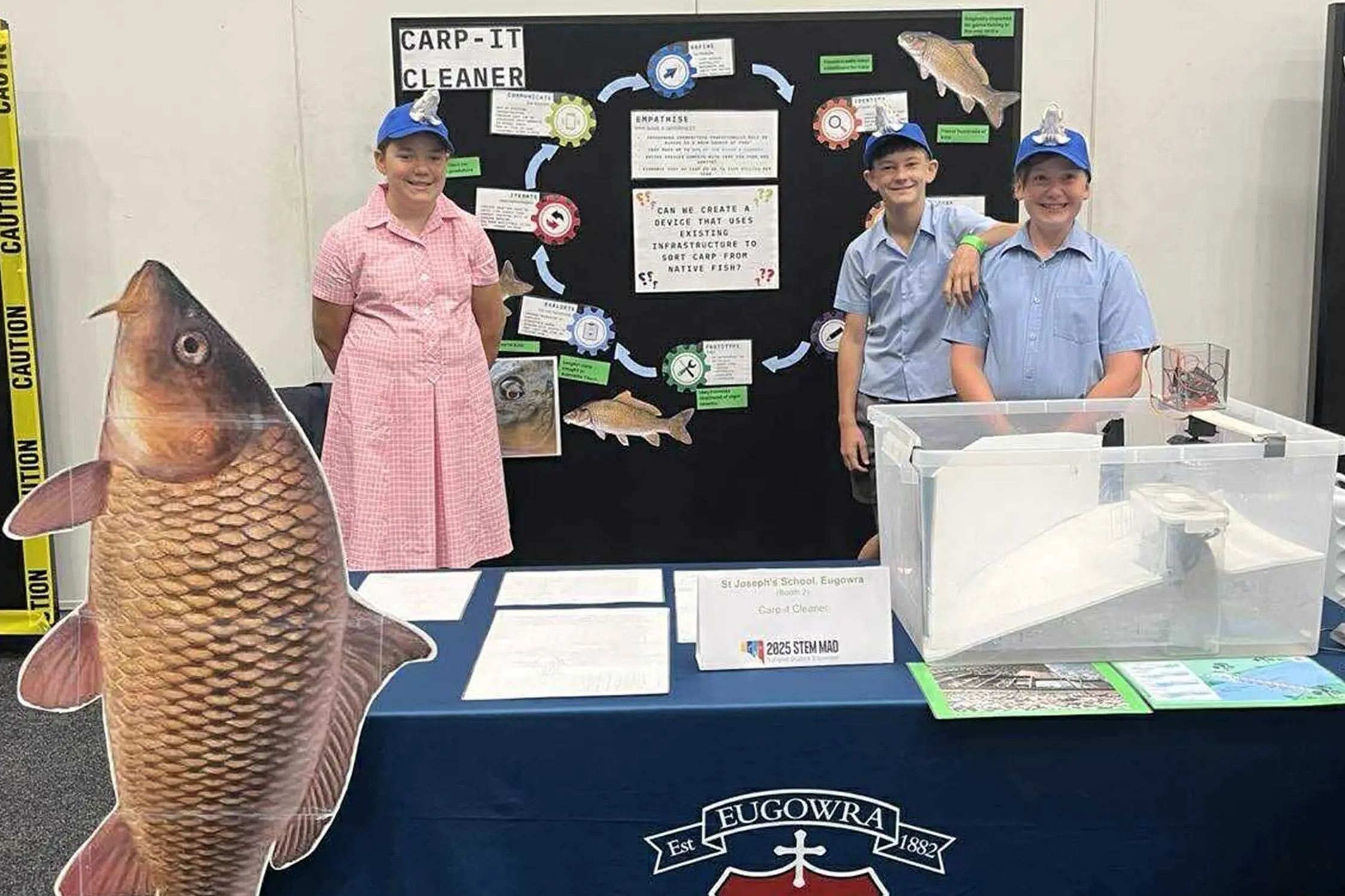 <p>St Josephs Eugowra students Taleesha, Sam and Zac took their Carp-It Cleaner prototype to the national STEM MAD showcase. </p>\\n