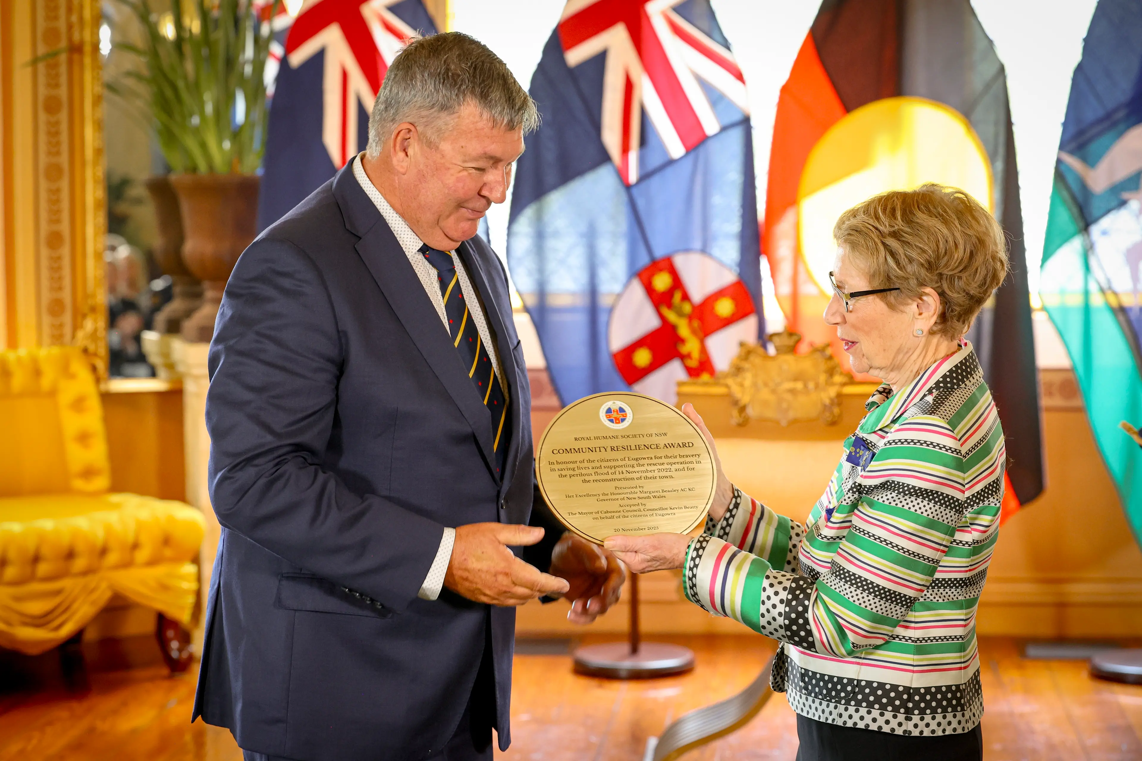 <p>Cabonne Mayor Kevin Beatty accepts the inaugural Royal Humane Society of NSW Community Resilience Award for Eugowra from Her Excellency the Honourable Margaret Beazley AC KC, Governor of New South Wales. PHOTOS: Royal Humane Society of NSW</p>\\n
