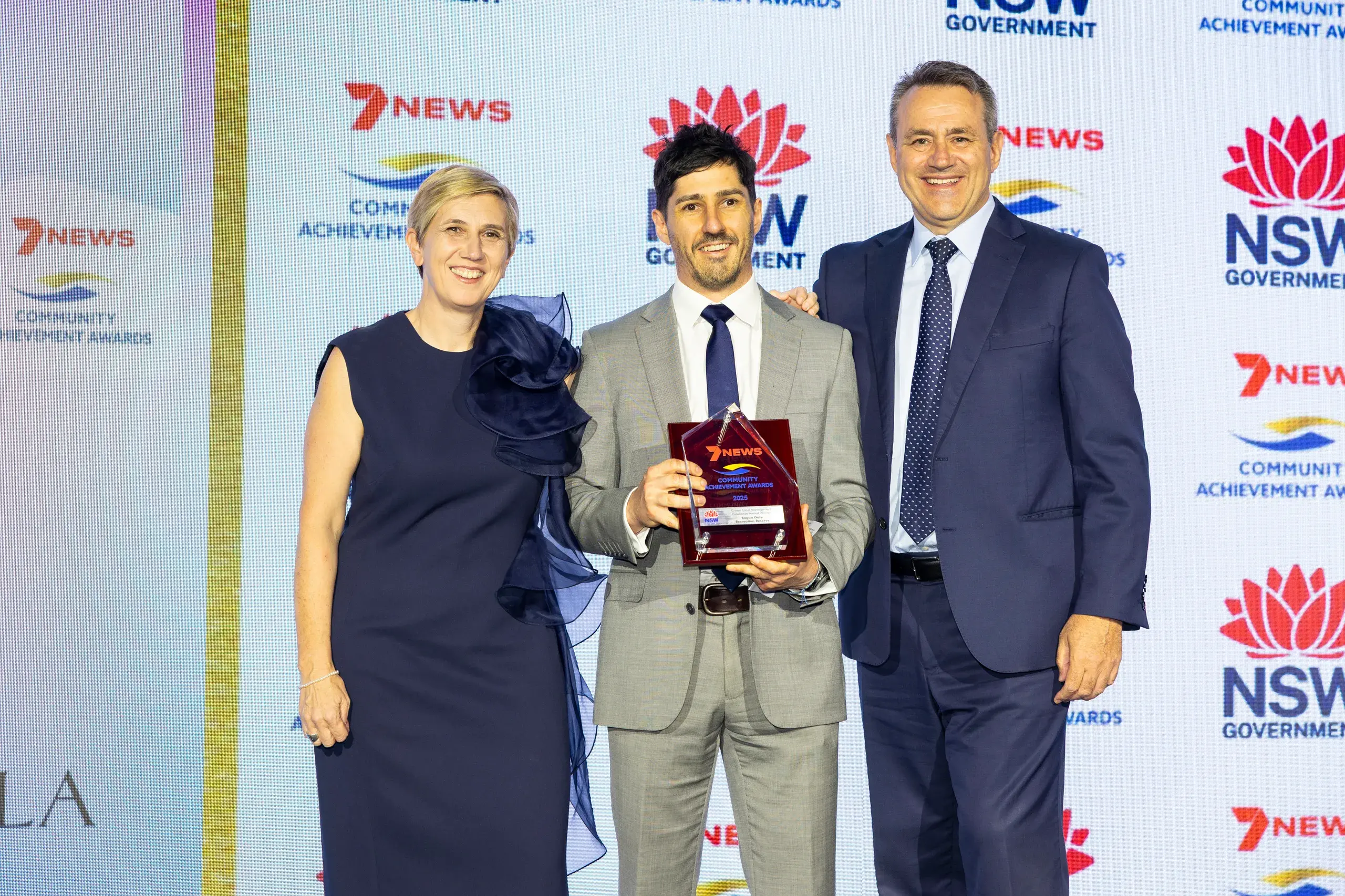 <p>Bogan Gate Recreation Reserve Board member James Buchanan accepted the award from Crown Lands deputy secretary Melanie Hawyes and Minister for Lands and Property Stephen Kamper.</p>\\n