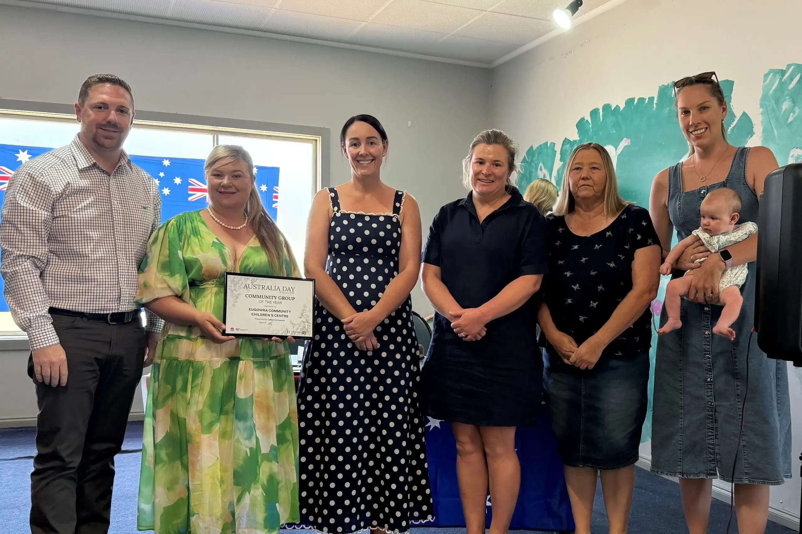 <p>Cabonne Deputy Mayor Jamie Jones congratulates Eugowra Community Children\\'s Centre representatives Lydia Herbert, Kate Langfield, Katrina Noble, centre director Raewyn Molloy, and Caroline Townsend holding little Olivia. </p>\\n