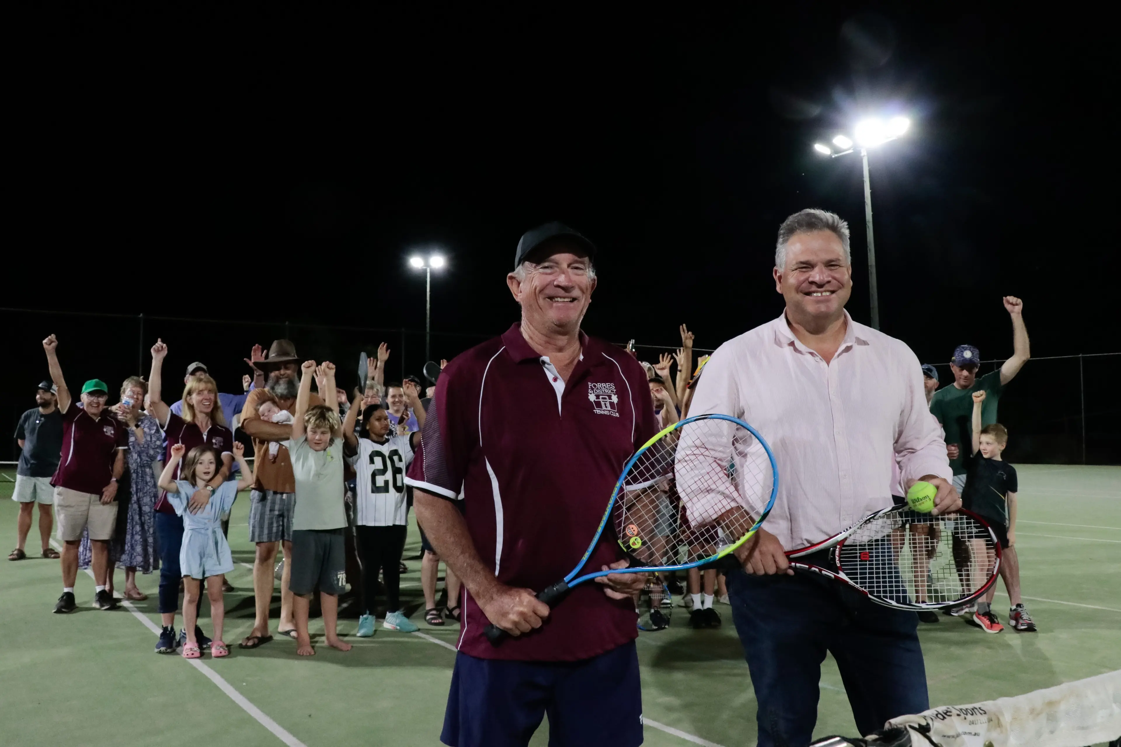 <p>Club president Peter Clifton and MP Philip Donato with Forbes tennis club members and contractors celebrating the new lighting and club improvements. </p>\\n