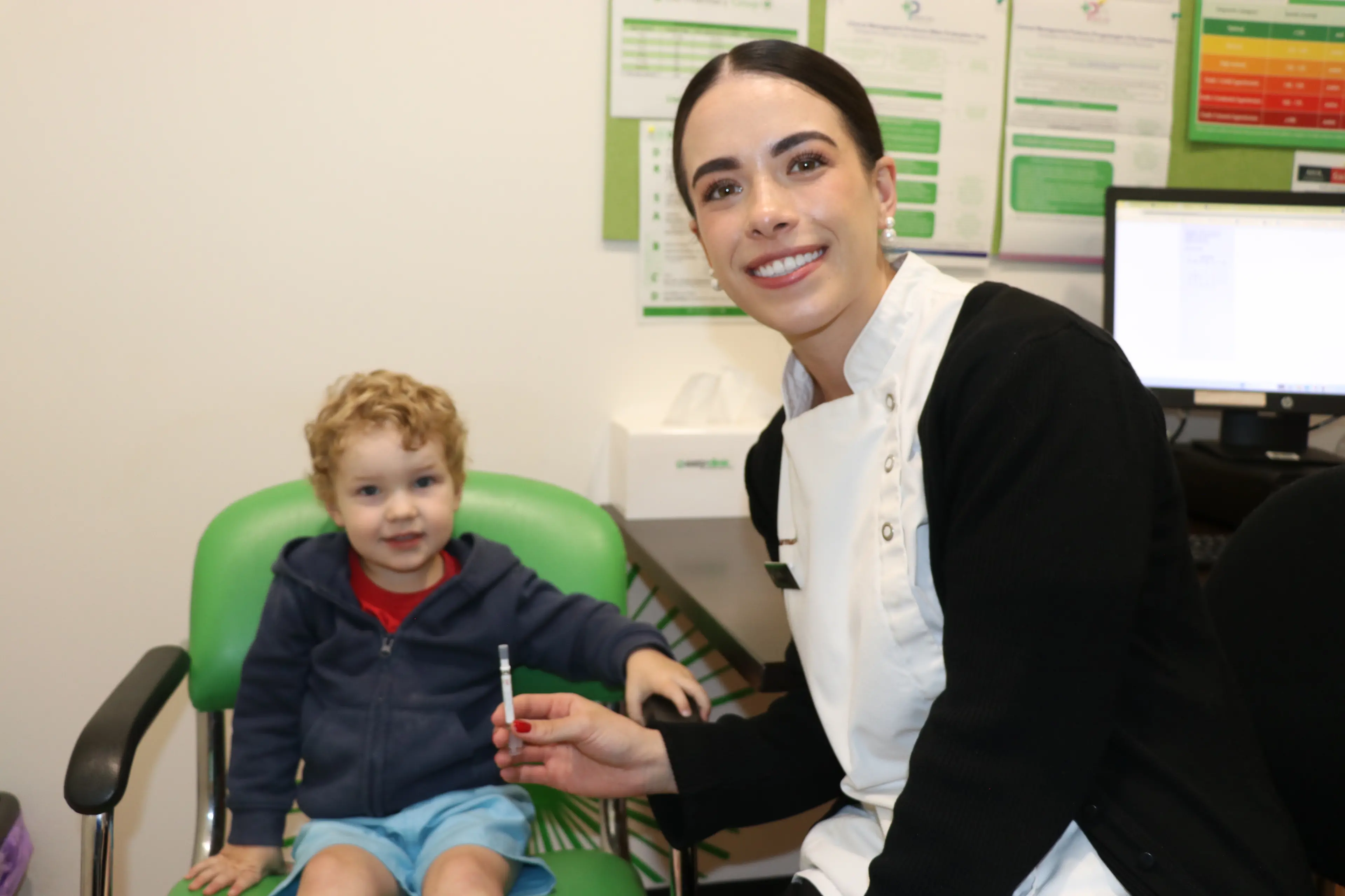 <p>Flu vaccination now as easy as a nasal spray ... little George Nash with pharmacy intern Sami Duggan. </p>\\n