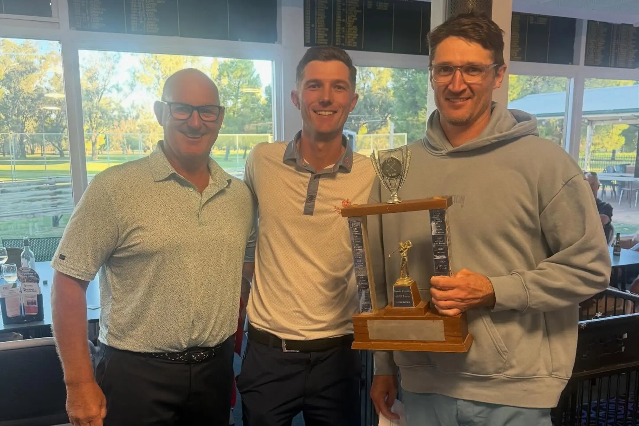 <p>Club president Stuart French congratulates winners Caleb Hanrahan and Timothy West (68). PHOTOS: Forbes Golf </p>\\n
