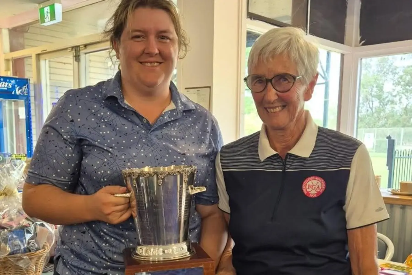 <p>Division 1 winner Brianna Duncan is congratulated by Ladies Golf President Sally Perry.</p>\\n