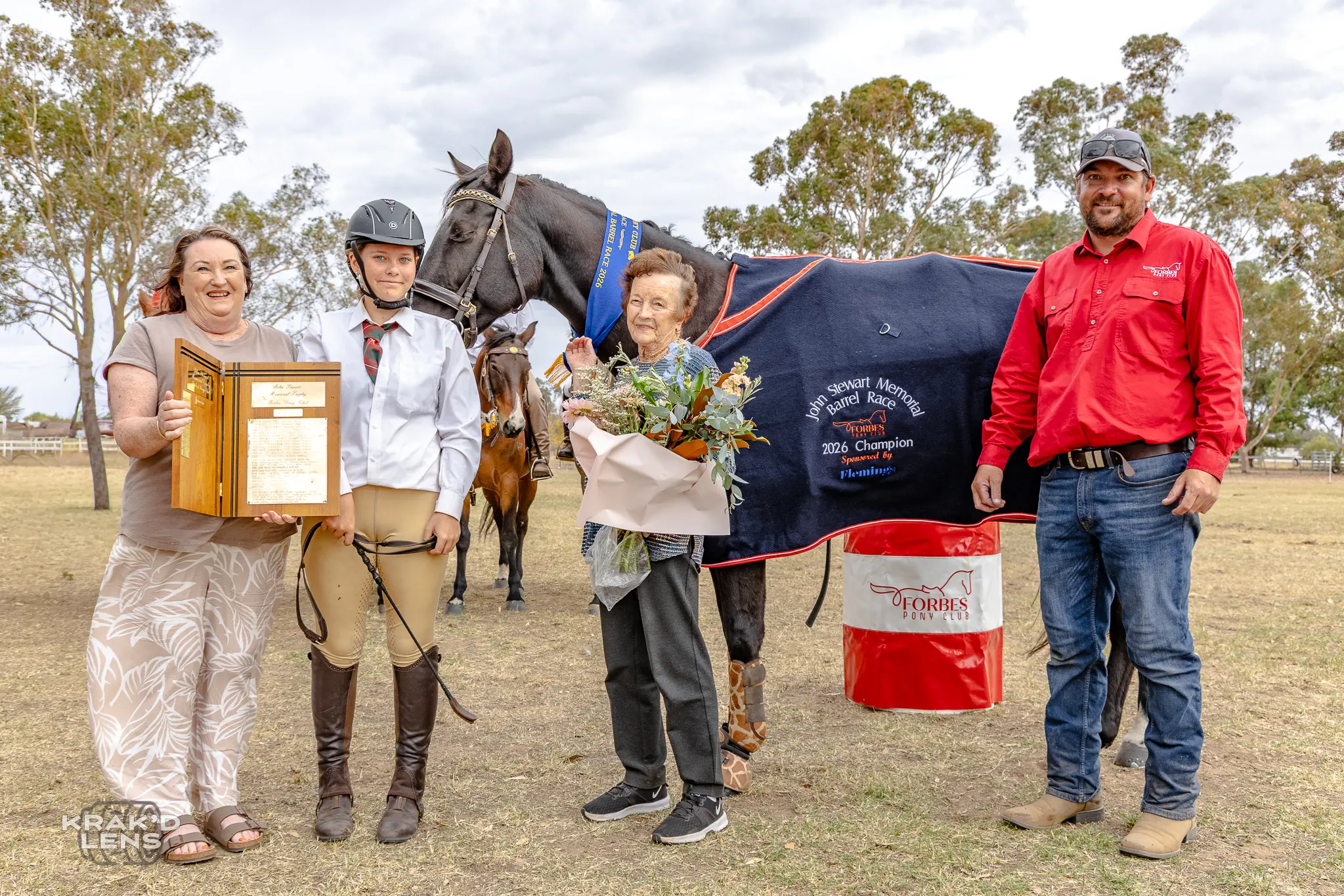 <p>Abi Bembrick is presented with the John Stewart Memorial for the barrel racing by Cathy Welsh, Loris Stewart and club president Luke White, she was also named the B Grade champion and C Grade champion as part of the Charlie O\\'Connor jumping day. PHOTOS: Steve Krakouer Krak\\'d Lens</p>\\n
