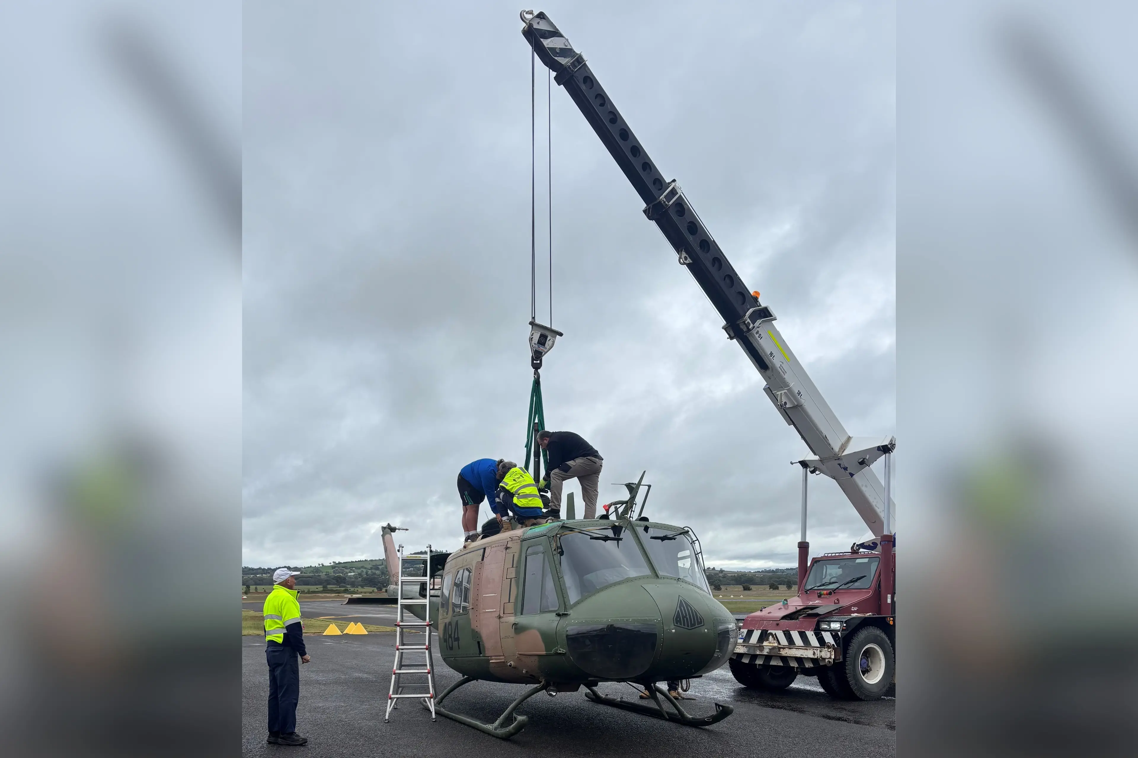 <p>Mike De La Hunty overseeing the arrival of the Bell UH-1H Iroquois helicopter at the Parkes HARS Aviation Museum at the Parkes Airport.</p>\\n