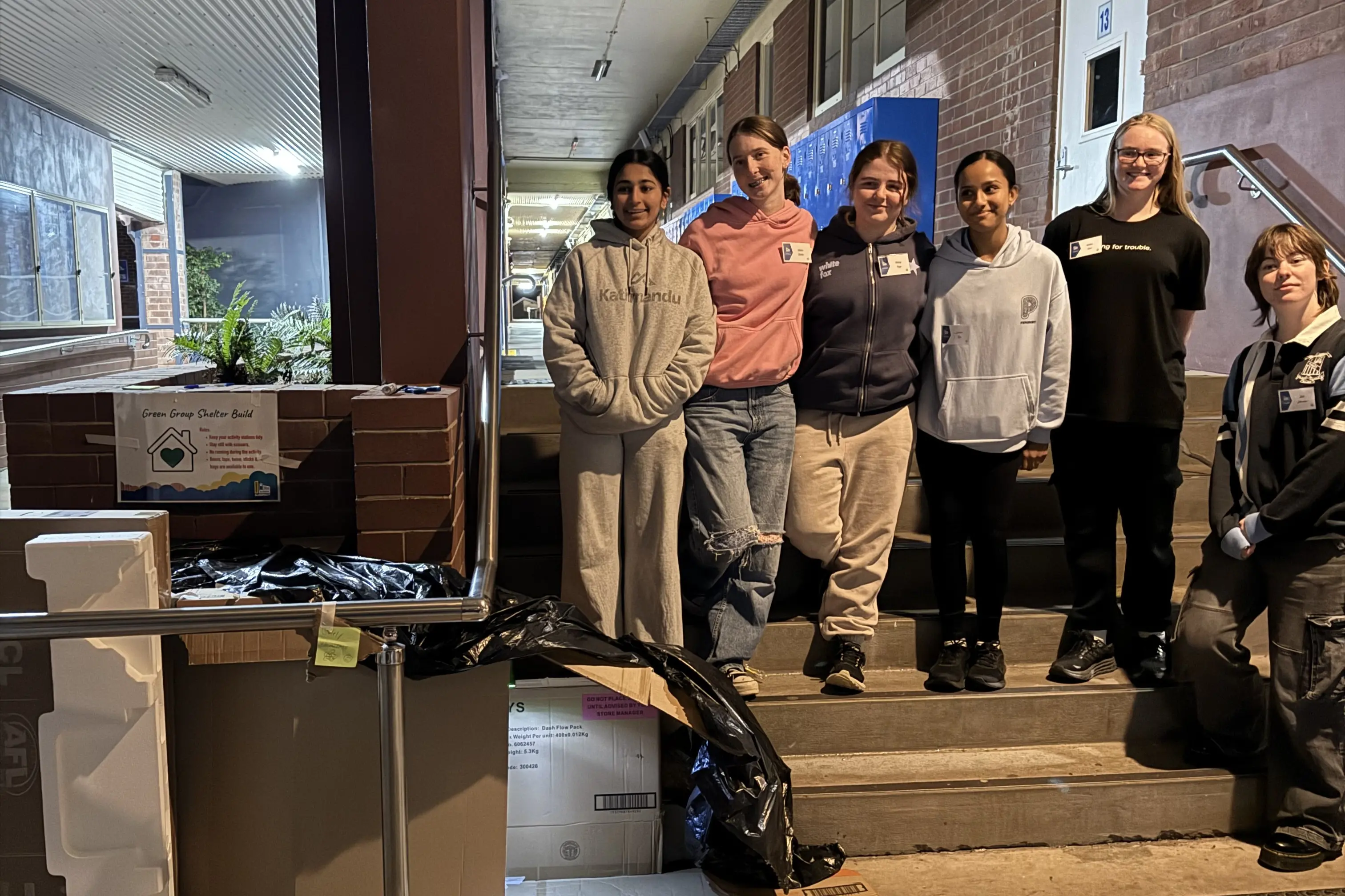 <p>Gabriella Pereira, Katie Corke, Abbey Fuge, Isabel Siju, Kaltia Cain, Zali Johnson with the shelter they built from found materials in the quad.</p>\\n