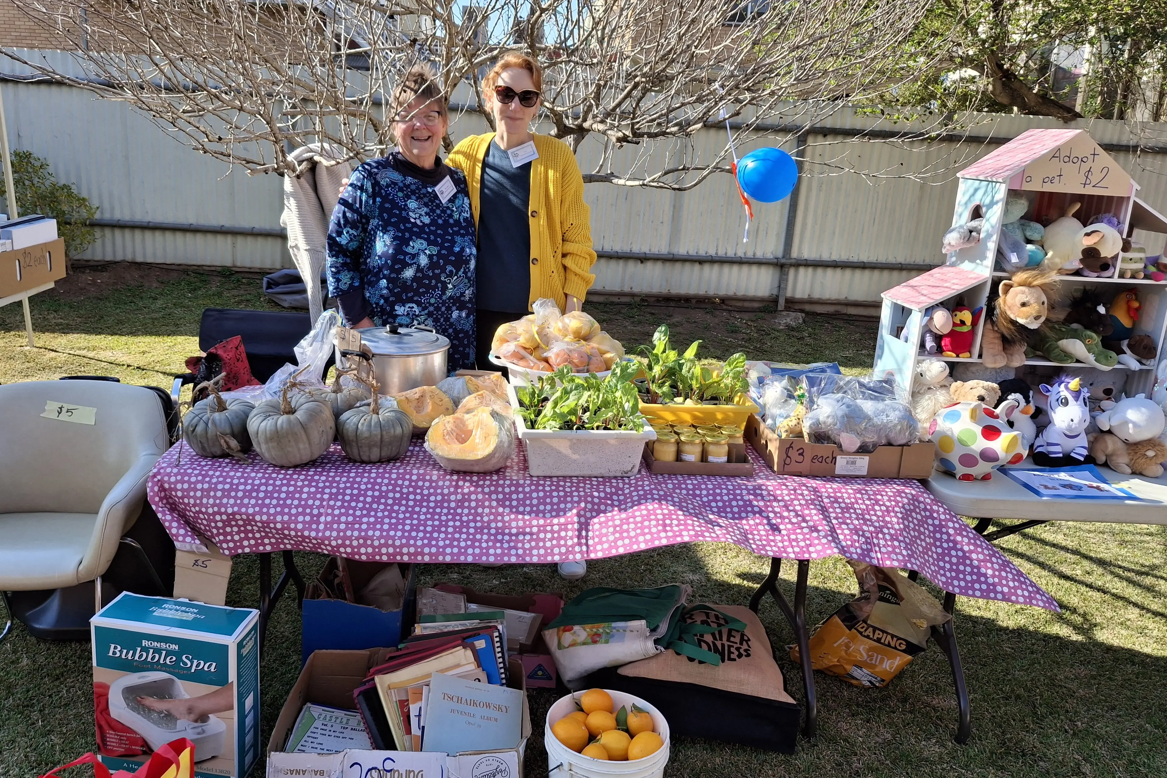 <p>Sue-anne Nixon and Jess Whalan selling goodies on the book and white elephant stall. </p>\\n