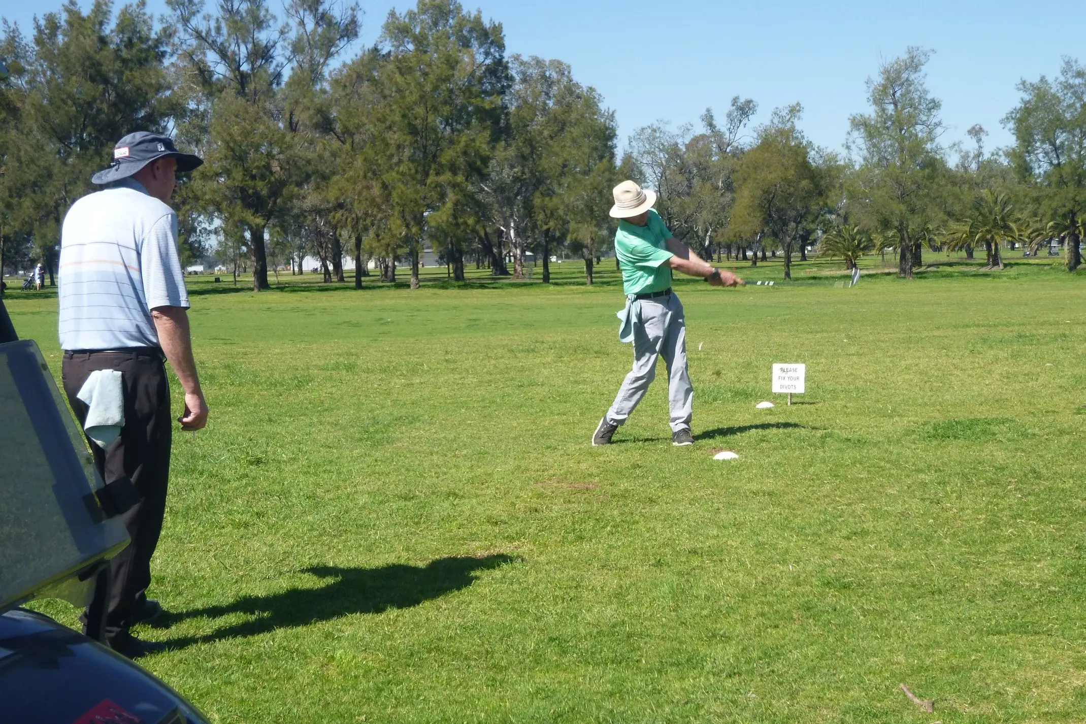 <p>Ken Sanderson tees off under the watchful eye of partner Niel Duncan. PHOTO: Short Putt</p>\\n