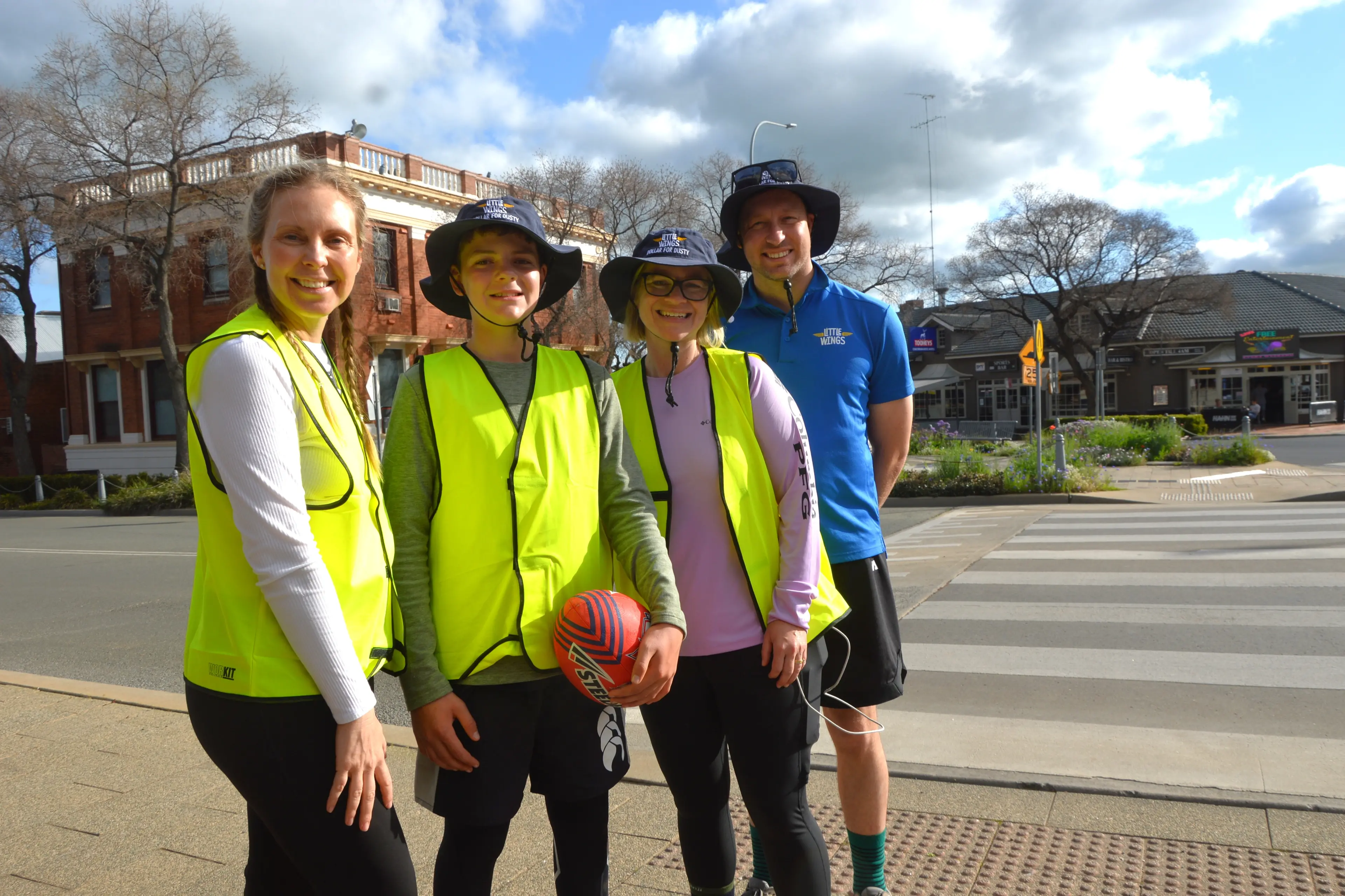 <p>Little Wings CEO Clare Pearson, Dusty Langby, his mum Sarah Langby and Andrew Bailey from Little Wings walking the Parkes CBD on Thursday afternoon. PHOTO: Christine Little</p>\\n