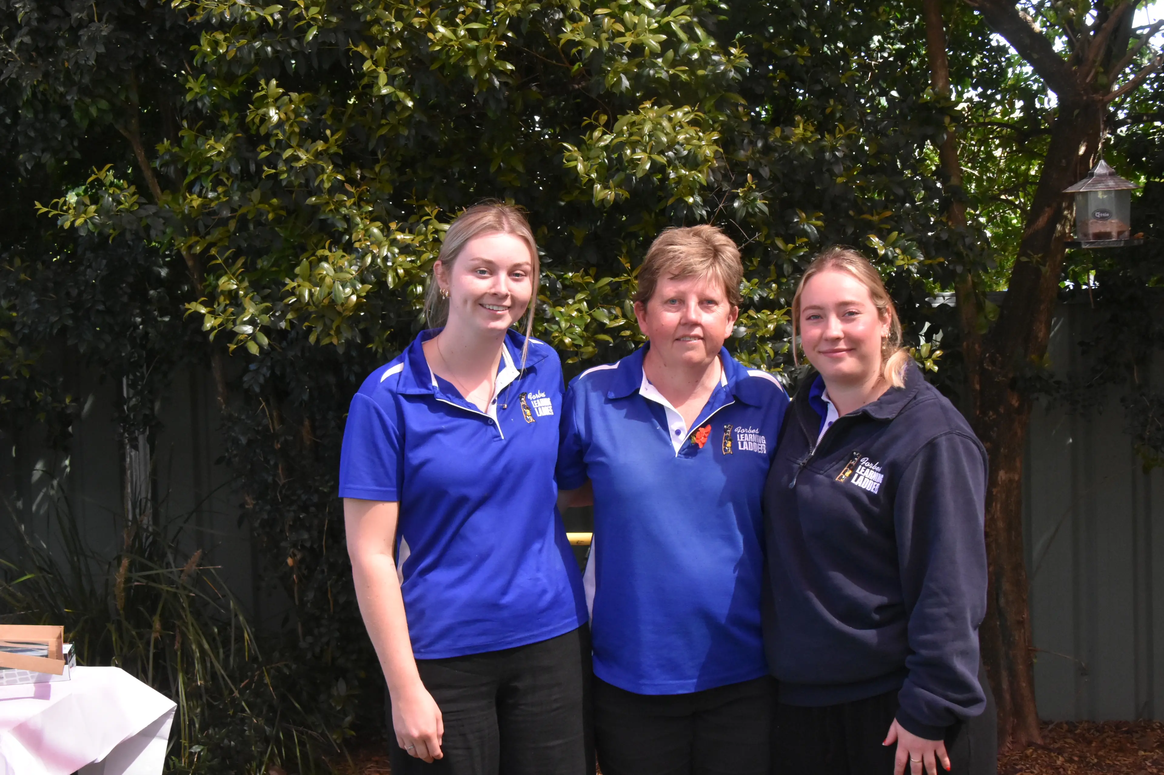 <p>Cathy Lawler (centre) has celebrated 20 years at Forbes Learning Ladder with former students turned co-workers Hallie Nicholson and Samantha Berry. </p>\\n